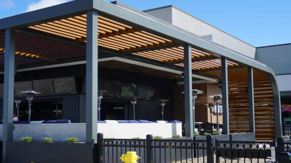 Covered restaurant patio with outdoor dining tables and seating
